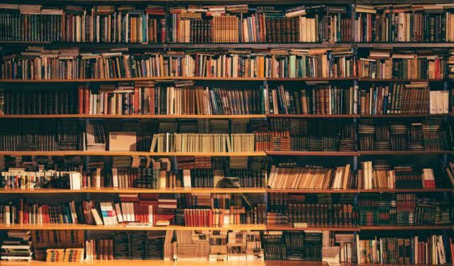 wide bookshelf crammed full with books