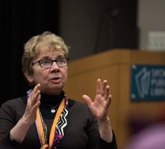 Photo of Jacqueline Briggs Martin speaking to a group at a meeting