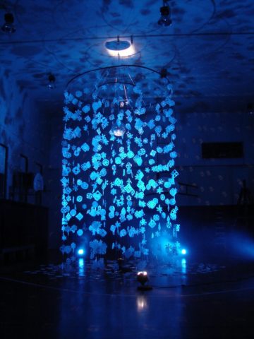 An art piece made of paper snowflakes and creative lighting