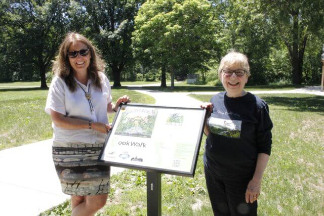 Authors standing next to the sign
