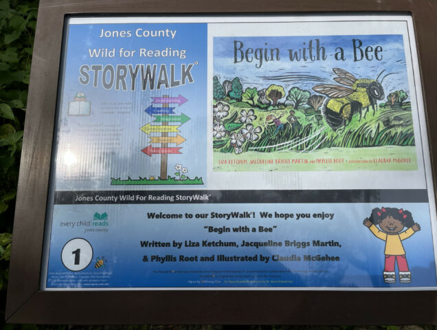 story walk signpost with Begin with a Bee book jacket
